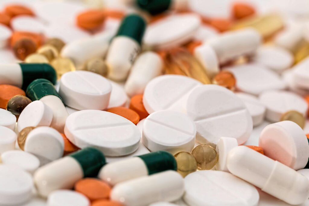 Drugs Close-up of various pills and capsules in different colors and sizes, ideal for healthcare-related content.
