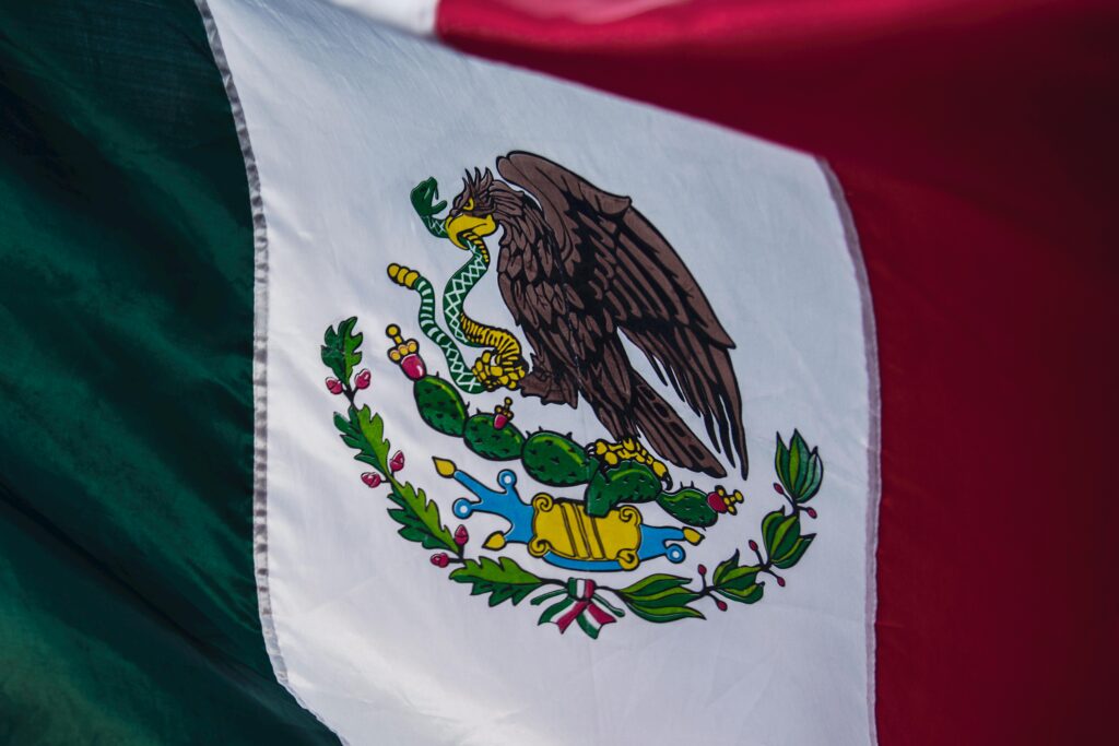 Mexico Detailed close-up of the Mexican flag showcasing its vibrant colors and emblem.