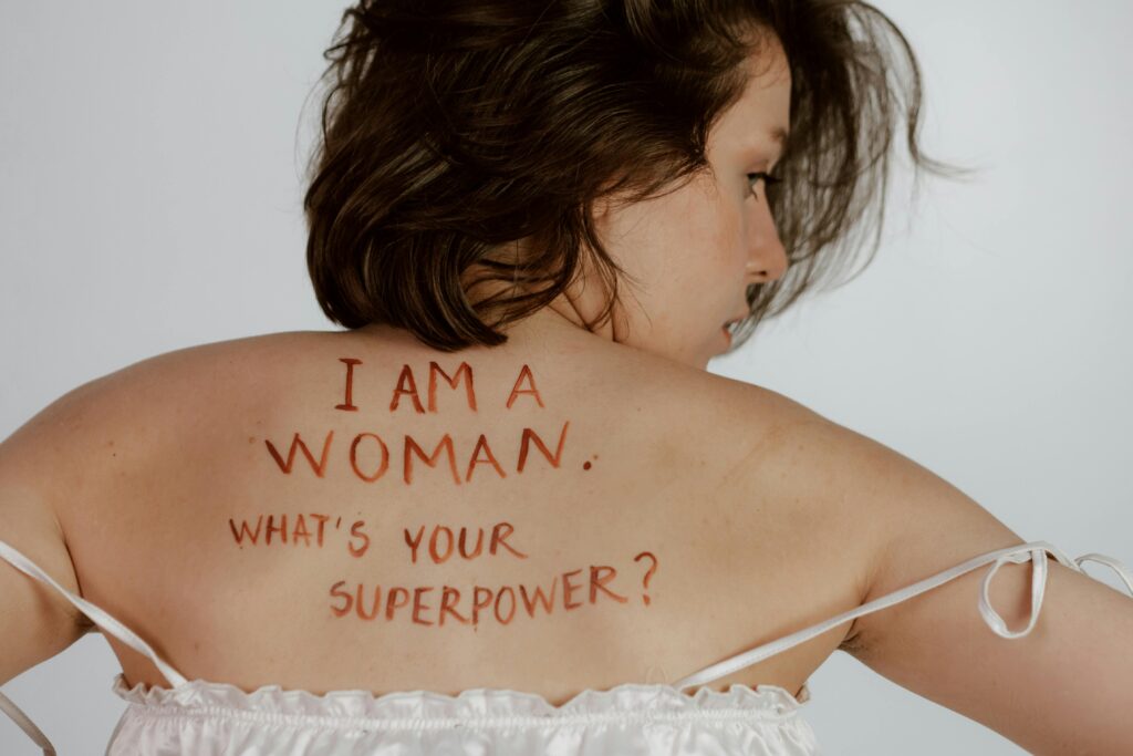 Feminism Back view of woman with empowering message, promoting self-love and feminism.