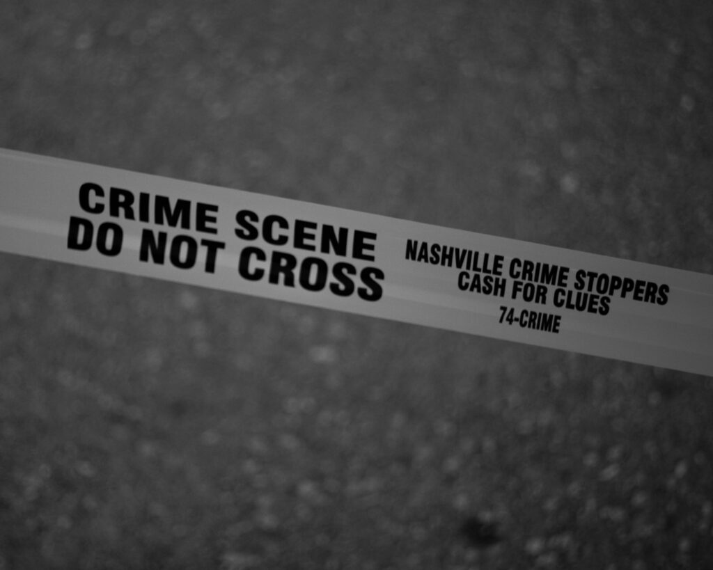 Crime Black and white close-up of crime scene tape with Nashville text.