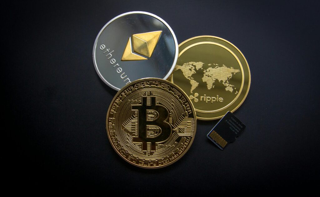 Cryptocurrency A striking image of Bitcoin, Ethereum, and Ripple coins illustrating modern digital currency.